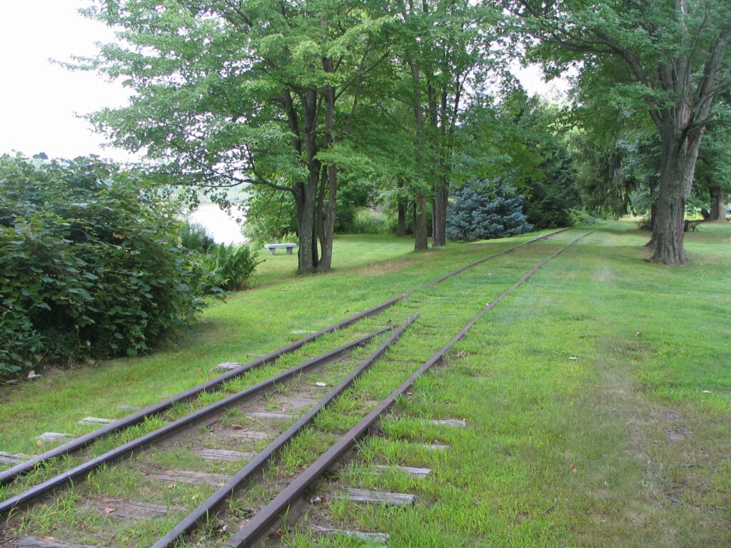 The original railroad tracks running along Harbor Pond